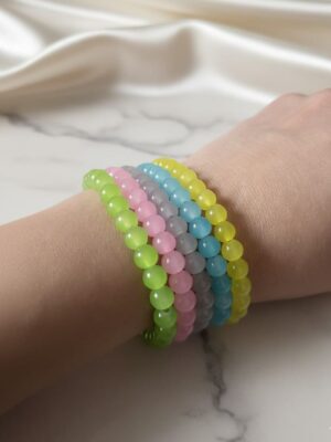 Pastel beaded bracelet stack with colorful translucent beads