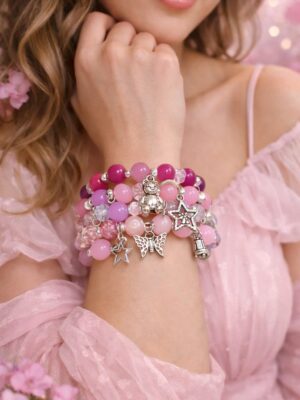 Pink charm bracelet stack with teddy, butterfly and star charms
