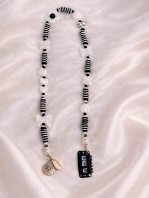 Black and white clip-in hair extension with beaded striped design