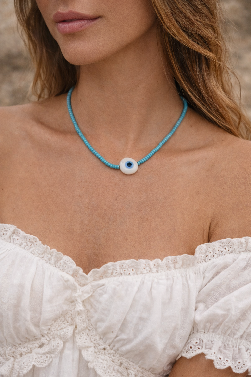 Close-up of classic evil eye pendant with luminous blue glass beads