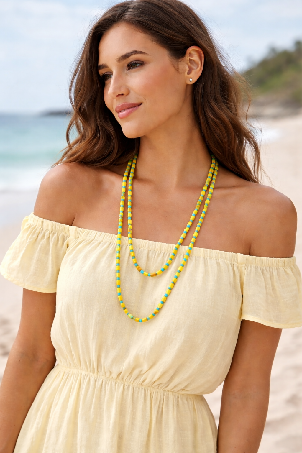 Close-up of yellow and turquoise beaded long chain necklace