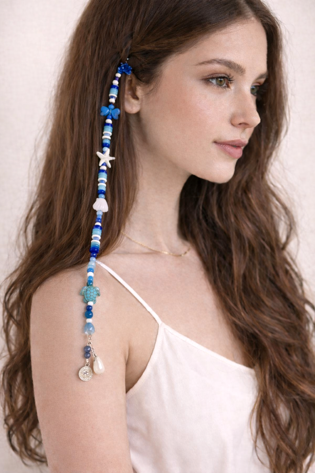 Close-up of ocean-inspired beaded hair clip with starfish and ghungroo bells