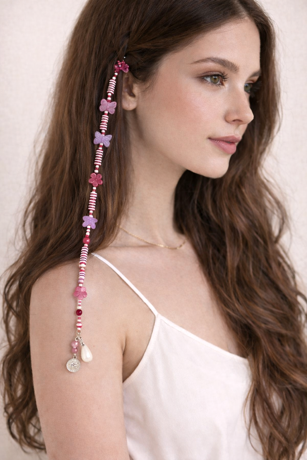 Close-up of pastel beaded hair clip with heart accents and dangling charms
